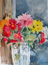 A watercolor of colorful flowers, pink, red, yellow, orange and white in a crystal vase.