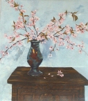 An oil painting of a simple rustic night table with a rachu pinch pot full of Almond blossoms against a white wall. The flowers shadows are cast on the wall and there are little pink petals on the wooden night stand.