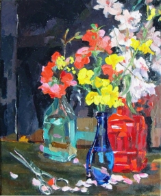 This is a small oil painting of blue bottles with a red bottle and spring flowers.